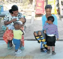  ??  ?? TOTS: Thandi Mkhwanazi and Nomusa Sithole care for children at the crèche