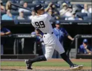  ?? SETH WENIG — ASSOCIATED PRESS ?? Aaron Judge hits his 49th and rookie record-breaking 50th home run in Yankees’ victory over Royals on Monday.