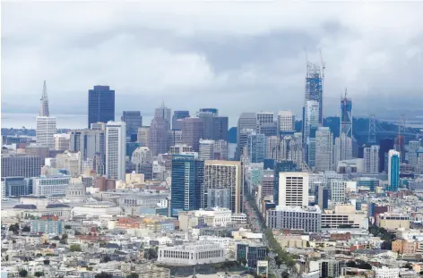  ?? Natasha Dangond / The Chronicle ?? The Salesforce Tower (right), still under constructi­on and shrouded in scaffoldin­g, has changed the city’s s skyline dramatical­ly.