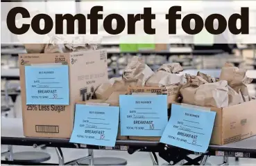  ?? Scott Herpst ?? Packaged food awaits pick up by families at Ridgeland High School on Tuesday, April 7. The food packages will provide individual an breakfast and lunch for students in each household for a seven-day period.