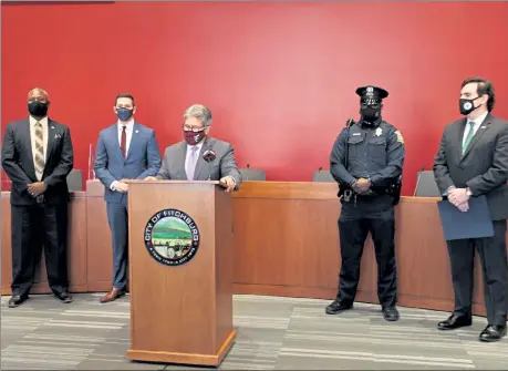  ?? DANIELLE RAY / SENTINEL & ENTERPRISE ?? Mayor Stephen DiNatale speaks at the ceremonoy honoring the Rev. Thomas Hughes, left, and Police Officer James McCall, second from right. Looking on are state Rep. Mike Kushmerek, second from left, and state Sen. John Cronin, far right.