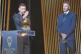  ?? ?? Inter Miami co-owner David Beckham presents Lionel Messi with his eighth Ballon d'Or in October 2023.