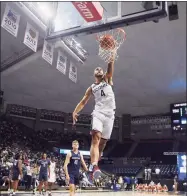  ?? Jessica Hill / Associated Press ?? UConn’s Tyrese Martin dunks during First Night events for the men's and women's basketball teams on Friday in Storrs.