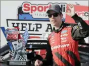  ?? TERRY RENNA — THE ASSOCIATED PRESS ?? Brad Keselowski stands with his trophy in Victory Lane after winning the NASCAR Xfinity Series auto race at Darlington Raceway, Saturday in Darlington, S.C.