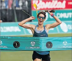  ??  ?? SURPRISE: Ladies winner Ann Ashworth breaks the tape of the 2018 Comrades Marathon to secure her first top 10 finish for the iconic race