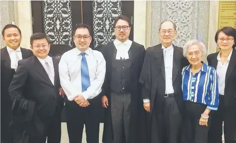  ??  ?? Chong (third left) with his legal counsels and family members at the courthouse in Putrajaya. — Photo courtesy of Malaysiaki­ni