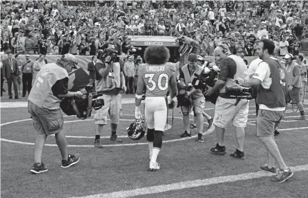  ?? Eric Lutzens, The Denver Post ?? Broncos running back Phillip Lindsay walks off the field after the Broncos’ 2019 win over the Oakland Raiders. Lindsay, at 5foot9, is being used as if he were a significan­tly bigger player.