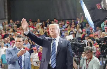  ?? — AFP ?? US President Donald Trump waves to the crowd during a “Make America Great Again” rally in Billings, Montana, on Thursday.