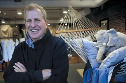  ?? STEVEN SENNE — THE ASSOCIATED PRESS ?? Chris Welles, owner of American Rhino, stands for a photograph at his apparel store in Boston. Welles isn’t taking chances with holiday staffing. He’s paying seasonal employees more than last year and offering sports and theater tickets to persuade people to work at his stores rather than at giants like Amazon.