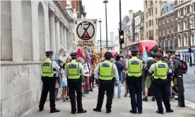  ??  ?? Police at an Extinction Rebellion protest in Whitehall. Photograph: Dave Rushen/Sopa Images/Rex/Shuttersto­ck