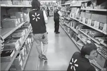  ?? PATRICK T. FALLON BLOOMBERG ?? Retailers such as Walmart have made headlines for raising their minimum hourly wages, while 29 states and the District of Columbia now require that employers pay more than the federal minimum wage of $7.25 per hour.