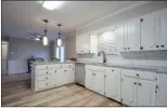  ??  ?? The spacious kitchen features subway-tiles back-splashes and stainless-steel appliances.