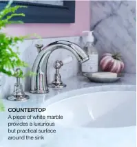  ??  ?? COUNTERTOP
A piece of white marble provides a luxurious but practical surface around the sink