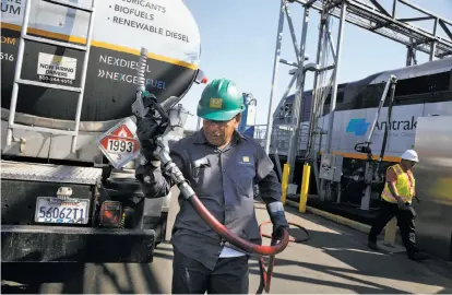  ?? Lea Suzuki / The Chronicle ?? Memo Terrones of Golden Gate Petroleum fills a Capital Corridor locomotive with renewable diesel in Oakland.