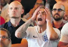  ?? GAVIN YOUNG ?? English fan Rhys Carpenter reacts as he watches Croatia defeat England in the World Cup Soccer semifinal at the Rose &amp; Crown Pub. His fellow fans were stunned by the loss.