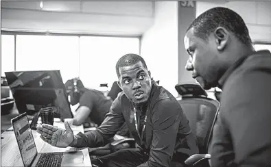  ?? The New York Times/TOM SAATER ?? Jolomi Otumara (left) Andela’s director of apprentice­ship products, works with Kamdi Uko, a product manager, in Lagos, Nigeria, in late September.