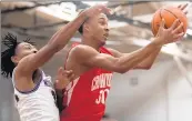  ?? KYLE TELECHAN/POST-TRIBUNE ?? Crown Point’s David Brown grabs a rebound from Merrillvil­le’s Juwan Bandy on Friday in Merrillvil­le.