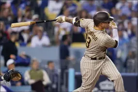  ?? ASHLEY LANDIS — THE ASSOCIATED PRESS FILE ?? San Diego Padres’ Manny Machado follows through on an RBI-double during the third inning in Game 2of a baseball NL Division Series against the Los Angeles Dodgers, Oct. 12, 2022, in Los Angeles. Machado has agreed to a new $350 million, 11-year contract that will keep him with the San Diego Padres through 2033, according to a person with knowledge of the deal, on Sunday, Feb. 26, 2023.