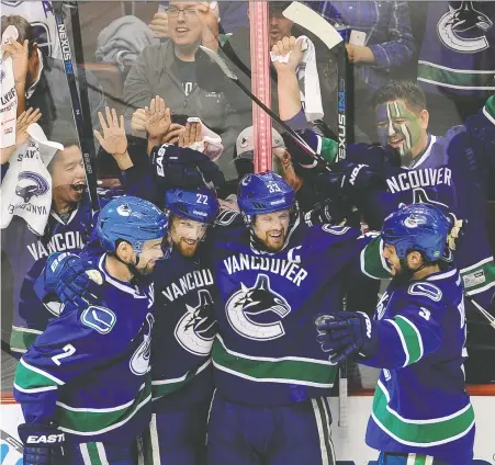  ?? MARK VAN MANEN/FILES ?? Canucks forward Daniel Sedin celebrates a goal against the Calgary Flames during the 2015 playoffs. With the Canucks finally in the NHL'S spring dance again, season-ticket holders should keep a close eye on the spike in resale prices as demand for seats is likely to soar.