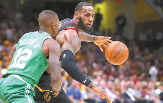  ?? AFP-Yonhap ?? LeBron James, right, of the Cleveland Cavaliers handles the ball against Terry Rozier of the Boston Celtics in the second quarter during Game Four of the 2018 NBA Eastern Conference Finals at Quicken Loans Arena in Cleveland, Ohio, Monday.