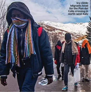  ??  ?? Icy climb: Migrants head for the Pian del Colle crossing in north-west Italy