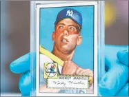  ?? David Zalubowski / Associated Press ?? The “Holy Grail’ of baseball cards, a 1952 Topps Mickey Mantle, is put on display as part of baseball memorabili­a exhibit at the Colorado History Museum in Denver on Monday.