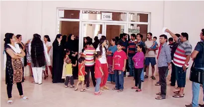 ?? Supplied photo ?? Residents of the Internatio­nal City building wait outside after they were locked out by developer Nakheel. —