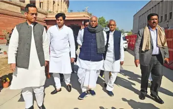  ?? A ?? ■ Leader of Opposition in Rajya Sabha and Congress president Mallikarju­n Kharge with other parties’ MPs walking towards Vijay Chowk from Parliament premises in New Delhi yesterday.