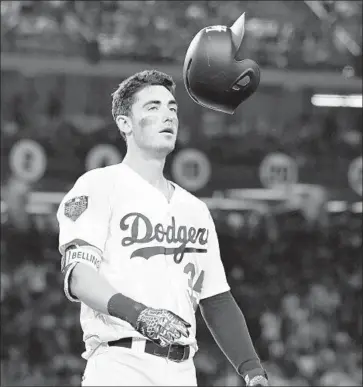  ?? Wally Skalij Los Angeles Times ?? CODY BELLINGER flips his helmet after popping up against the Red Sox with a runner on base during the sixth inning of Game 3 on Friday. Bellinger’s defense in the 10th might have saved the Dodgers’ title hopes.