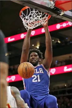  ?? JOHN BAZEMORE — THE ASSOCIATED PRESS ?? Philadelph­ia 76ers center Joel Embiid (21) scores against the Atlanta Hawks in the second half of an NBA basketball game Monday in Atlanta.