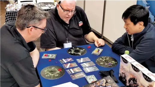  ?? ?? Du Shaofei (right) plays a Joypie board game with visitors to the Spiel Essen board game exhibition in Germany. The event is the world’s biggest board game exhibition. — Ti Gong