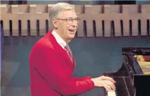 ?? LAKE FONG/PITTSBURGH POST-GAZETTE ?? Fred Rogers plays the piano while being interviewe­d in 2001. Rollins College will soon honor the esteemed alumnus with a musical program. Rogers died in 2003.