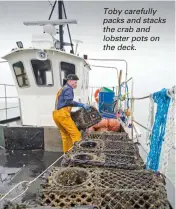  ??  ?? Toby carefully packs and stacks the crab and lobster pots on the deck.