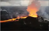  ?? AP FILE PHOTO BY U.S. GEOLOGICAL SURVEY ?? In this, July 14, photo provided by the U.S. Geological Survey, lava from Kilauea volcano erupts in the Leilani Estates neighborho­od near Pahoa, Hawaii.