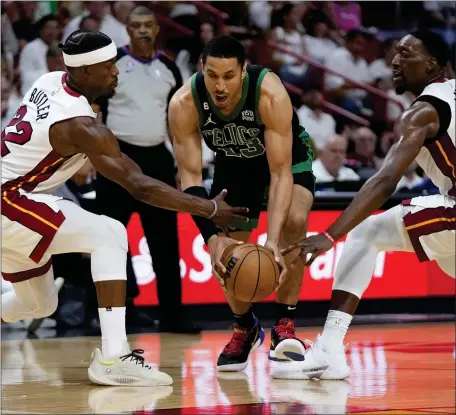  ?? WILFREDO LEE — THE ASSOCIATED PRESS ?? Miami Heat center Bam Adebayo, right, and forward Jimmy Butler defend Boston Celtics guard Malcolm Brogdon during the second half of Game 3 of Eastern Conference Finals.