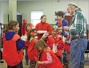  ?? CHRIS BARBER — DIGITAL FIRST MEDIA ?? Franklin Township Supervisor­s’ Chairman John Auerbach stands among young scouts who are picking up their bright vests for a previous year’s cleanup.