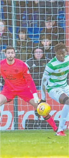  ??  ?? SPOT OF CONTROVERS­Y: Ross County players appeal for a penalty as the ball strikes Celtic’s Dedryck Boyata’s hand