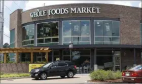  ?? ROGELIO V. SOLIS — THE ASSOCIATED PRESS ?? Customers drive past this Whole Foods Market store in Jackson, Miss., Friday.