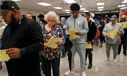  ?? Photograph: Leah Millis/Reuters ?? Voters wait in line to cast their votes in US midterm election in Georgia in 2018.