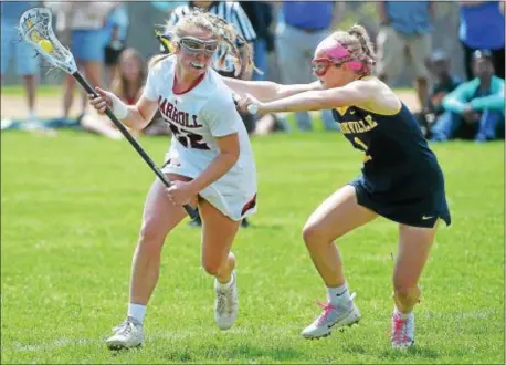  ?? PETE BANNAN — DIGITAL FIRST MEDIA ?? Archbishop Carroll’s Rachel Matey looks for maneuverin­g room around the dogged defense displayed Saturday by Unionville’s Shannon Garvey at the Katie Samson Lacrosse Festival at Radnor High School. Unionville took down Carroll 10-9.