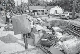  ?? Michael Ciaglo / Houston Chronicle ?? Catholic Charities USA member Patrick Fisher, of Chicago, unloads a truck full of supplies donated from people in Pittsburgh in Kashmere Gardens.