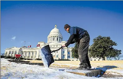  ?? Arkansas Democrat-Gazette/STATON BREIDENTHA­L ?? Kevin Brown of the grounds and maintenanc­e department at the state Capitol works Tuesday morning clearing sidewalks in front of the Capitol in Little Rock.