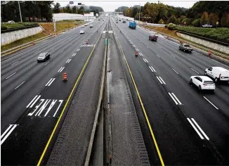  ?? CONTRIBUTE­D BY CASEY SYKES ?? New express lanes are shown on I-85 from the Lawrencevi­lle-Suwanee Road overpass Friday in Suwanee. The 10-mile extension of the I-85 express lanes in Gwinnett County, which open to traffic today, are the latest link in Georgia’s plans for 120 miles of toll lanes across the region.