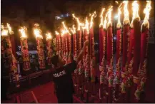  ?? AP ?? INDONESIA: An Indonesian ethnic Chinese man lights joss sticks Saturday during the Lunar New Year celebratio­n in Medan, North Sumatra.