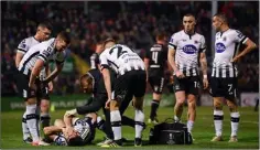  ??  ?? Patrick Hoban of Dundalk receiving attention after his injury.