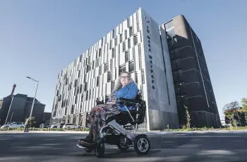  ?? ?? Lynne Birnie, who uses a wheelchair, had to wait for someone to open a door so she could leave a new car park building near Christchur­ch Hospital. CHRIS SKELTON/THE PRESS