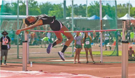  ?? PHOTOS BY JUAN ANTONIO LABRECHE/FOR THE NEW MEXICAN ?? Taos junior Faith Powell clears 5 feet, 4 inches on Saturday at the State Track and Field Championsh­ips in Albuquerqu­e. She won the event and helped her team claim a state title, the school’s first in four years.