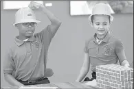  ?? Arkansas Democrat-Gazette/STATON BREIDENTHA­L ?? Williams Magnet Elementary School pupils Jaxon Owoh (left) and Madelyn Deloney, both 9, wait Wednesday for the AR Kids Read news conference to begin. Both children from the Little Rock school spoke during the news conference to announce the group’s...