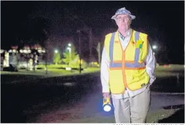  ?? JACOB LANGSTON/STAFF PHOTOGRAPH­ER ?? Bob Eubanks stands Tuesday morning in the darkness before the sun rises at his adopted son’s bus stop at the intersecti­on of Old Tavares Road and Tomato Hill Road in Leesburg.