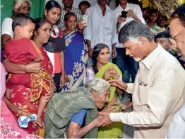  ?? — PTI ?? Andhra Pradesh chief minister N. Chandrabab­u Naidu interacts with an elderly woman during grama darshini village walk and grama sabha at Donepudi village in Guntur on Monday.